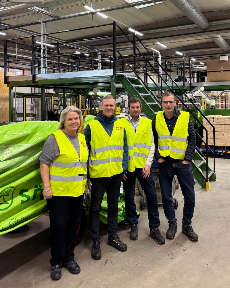 GLF and Södra representatives standing together at the Genarp factory discussing sustainable forestry.