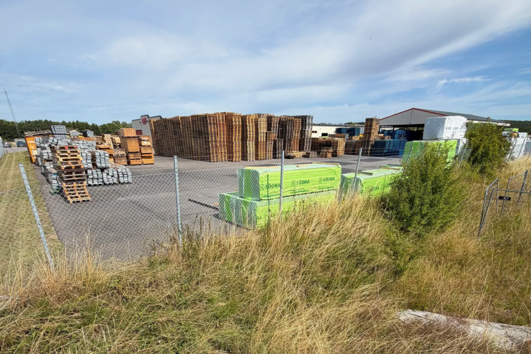 Stacks of wooden pallets and packaged timber at GLF’s existing warehouse area in Genarp.