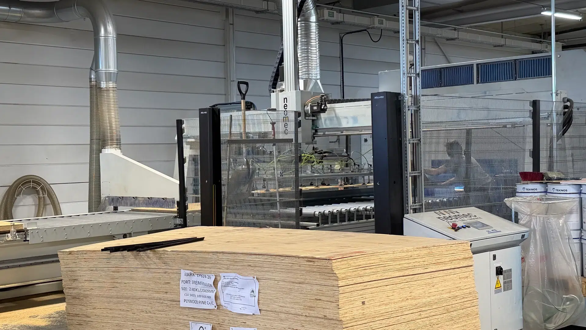 Stacked plywood beside the handling equipment.