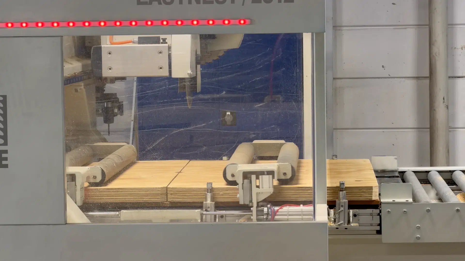 Tools and pressure rollers above the plywood in the Rierge machine.