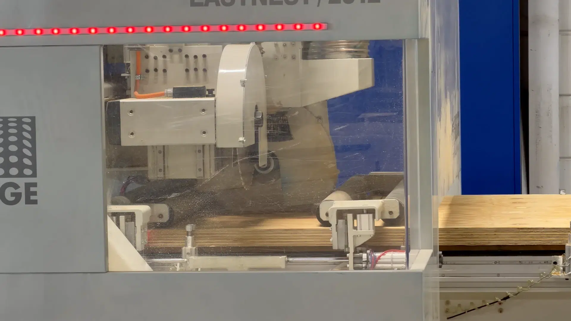 Saw blade beside the plywood sheets in the Rierge machine.