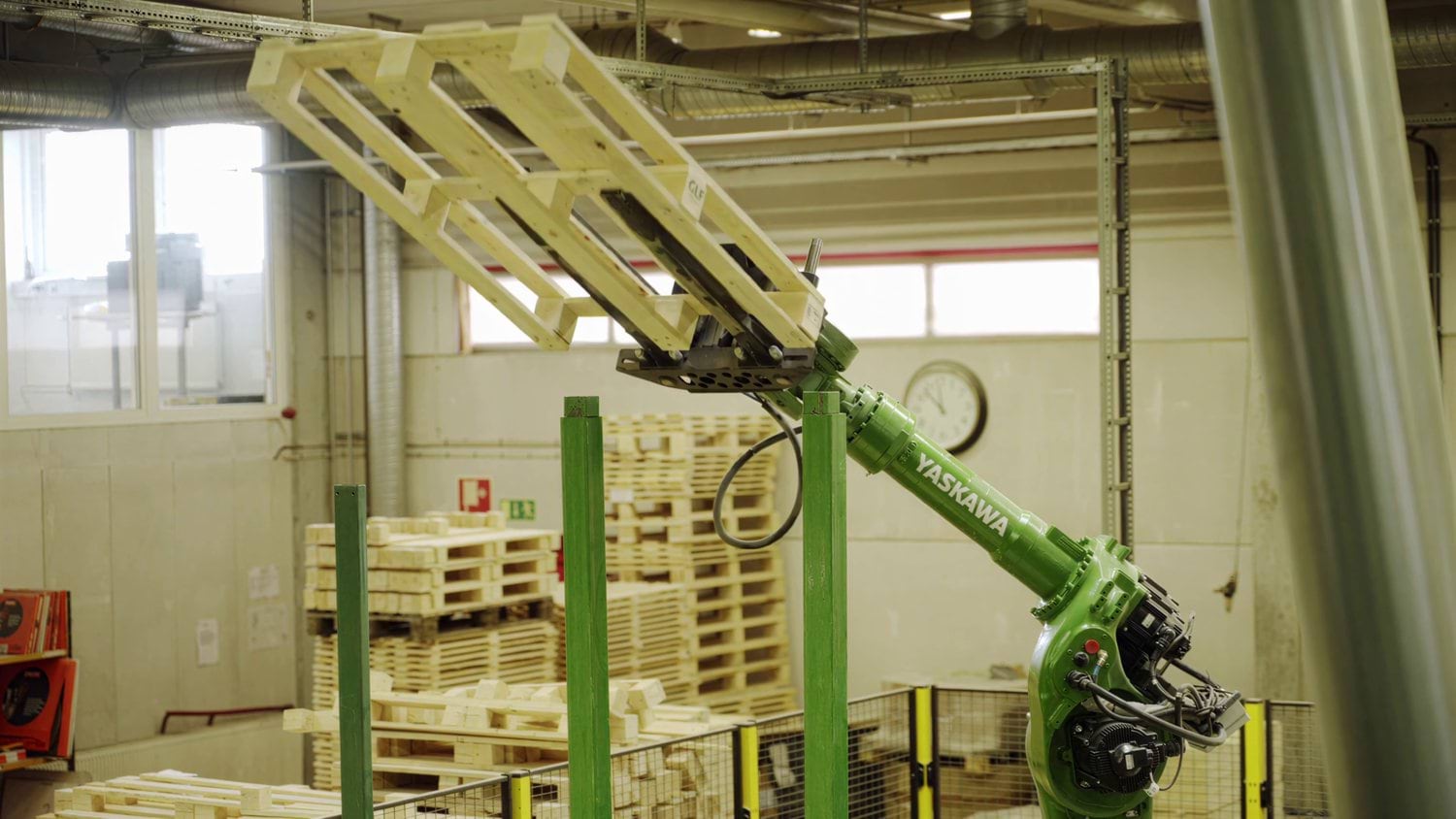 A robot handles finished wooden pallets in Genarp.