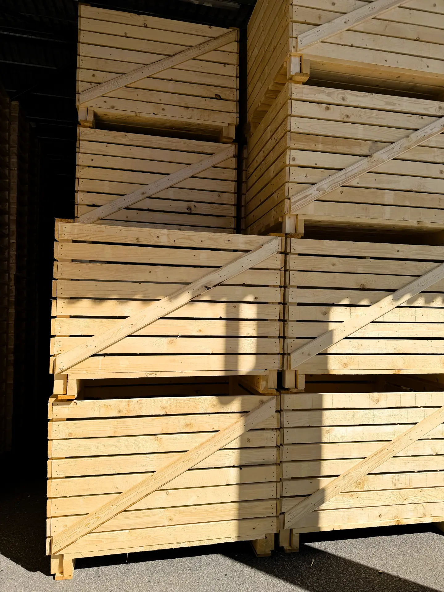 Stacked wooden crates with diagonal reinforcements.
